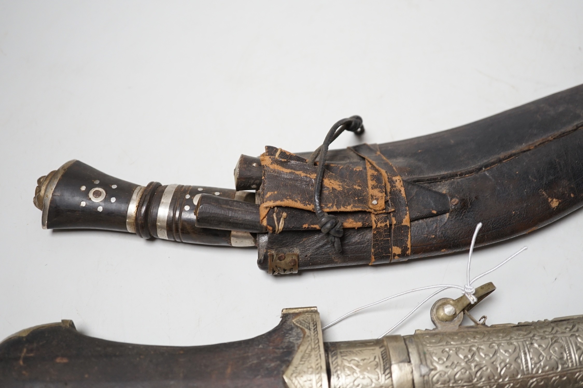 Two Kukri and eastern daggers, within engraved sheath, (3)